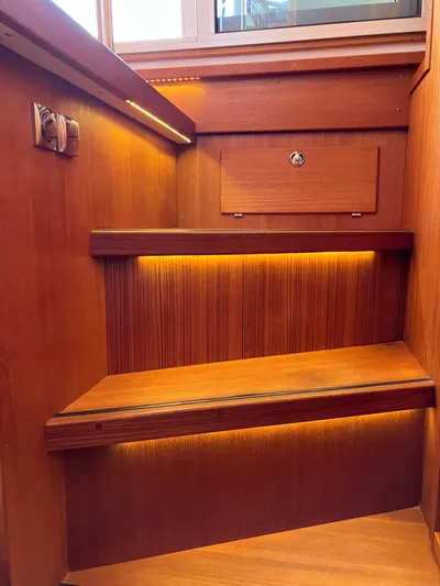  Yacht Photos Pics Wooden stairs with ambient lighting in a 2016 Targa 44 CFC boat interior.