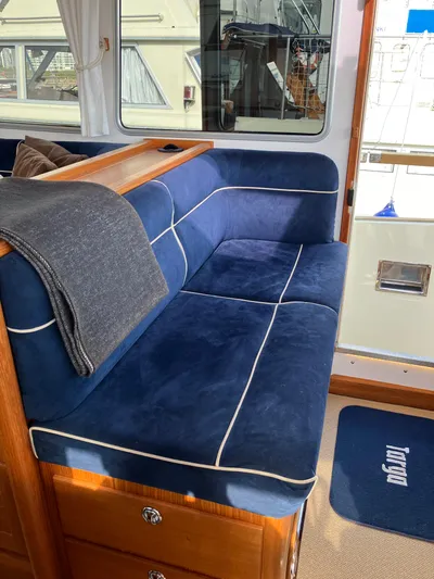  Yacht Photos Pics Interior of 2016 Targa 44 CFC boat with blue cushioned seating and wooden accents.