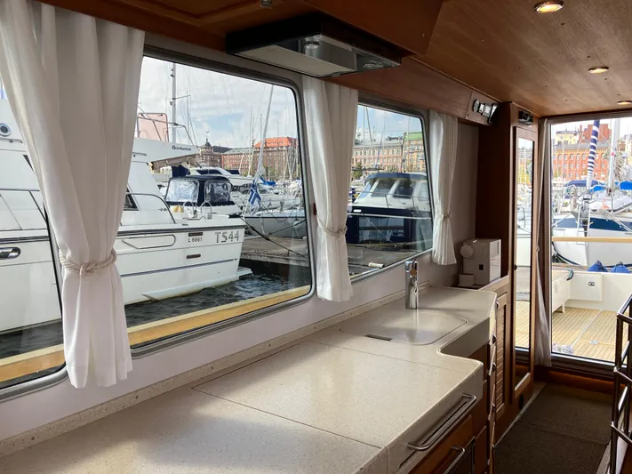  Yacht Photos Pics Interior view of 2016 Targa 44 CFC yacht with marina backdrop.