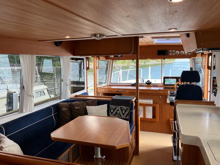  Yacht Photos Pics Interior of 2016 Targa 44 CFC yacht with wooden furnishings and scenic water view.