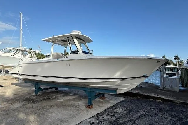  Yacht Photos Pics 2025 Pursuit S 288 Sport boat on display near waterfront.