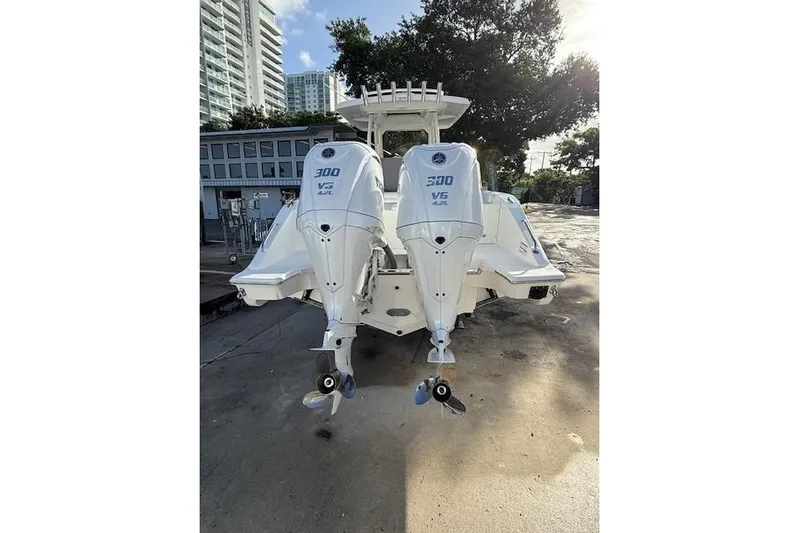  Yacht Photos Pics 2025 Pursuit S 288 Sport boat with dual 300 V6 engines, docked outdoors.