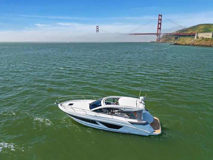 In Stock Yacht Photos Pics 2023 Beneteau Gran Turismo 41 yacht cruising near iconic bridge on a sunny day.