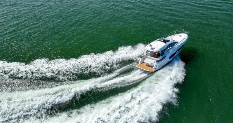 In Stock Yacht Photos Pics 2023 Beneteau Gran Turismo 41 cruising on open water, creating a dynamic wake.