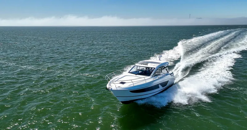 In Stock Yacht Photos Pics 2023 Beneteau Gran Turismo 41 cruising on open water, creating a dynamic wake.