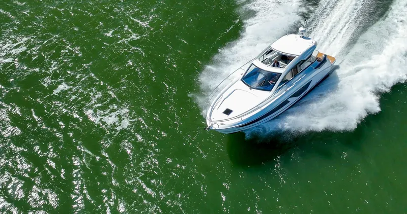 In Stock Yacht Photos Pics 2023 Beneteau Gran Turismo 41 cruising on vibrant green water.