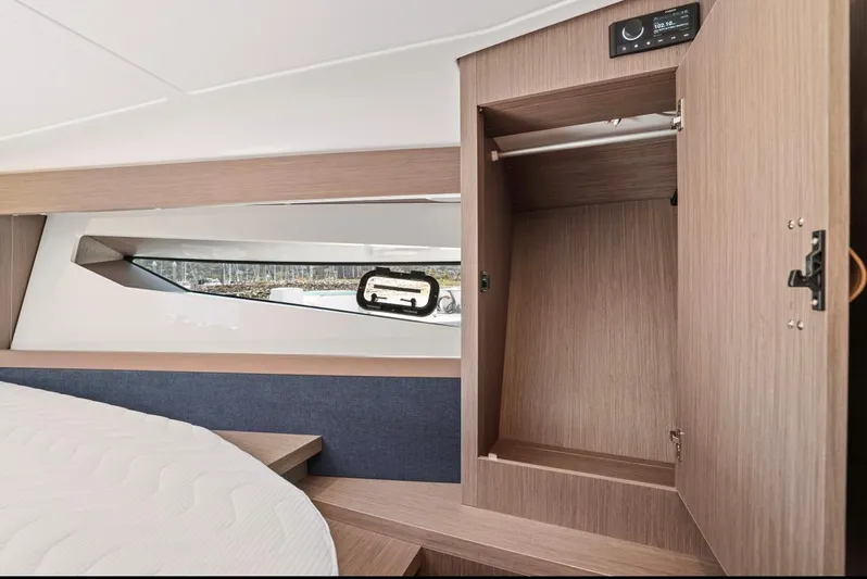 In Stock Yacht Photos Pics Interior of 2023 Beneteau Gran Turismo 41 yacht, featuring a wooden wardrobe and modern design.