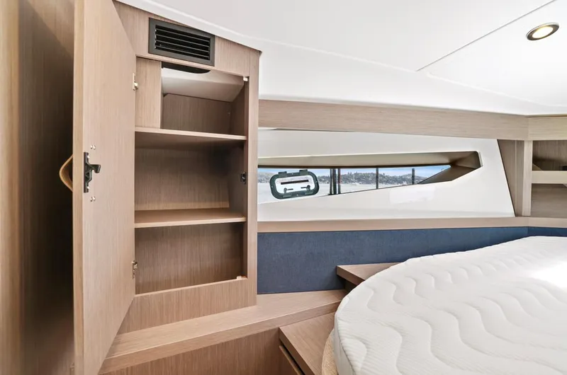 In Stock Yacht Photos Pics 2023 Beneteau Gran Turismo 41 cabin interior with open storage and round bed.