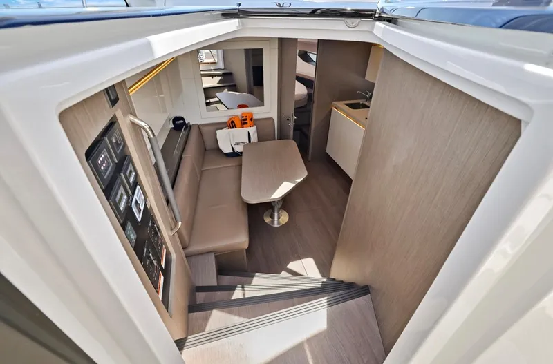 In Stock Yacht Photos Pics 2023 Beneteau Gran Turismo 41 interior with modern seating and table.