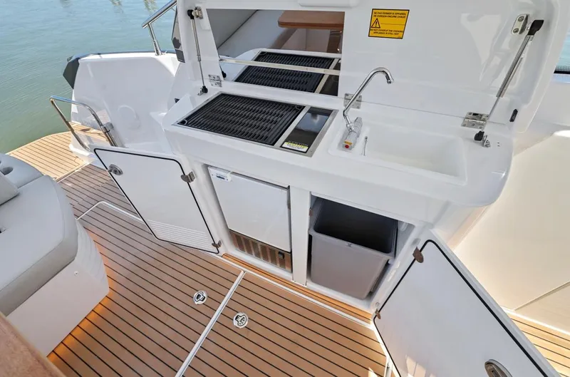 In Stock Yacht Photos Pics 2023 Beneteau Gran Turismo 41 yacht kitchen area with sink, grill, and storage.