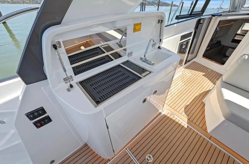 In Stock Yacht Photos Pics 2023 Beneteau Gran Turismo 41 yacht with outdoor kitchen and grill on deck.