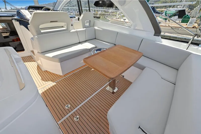 In Stock Yacht Photos Pics 2023 Beneteau Gran Turismo 41 yacht interior with sleek seating and wooden table.