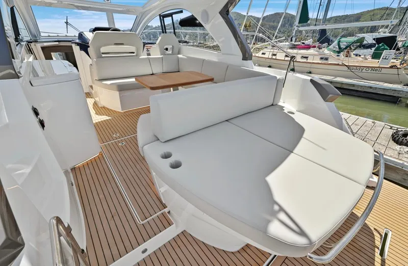 In Stock Yacht Photos Pics 2023 Beneteau Gran Turismo 41 yacht interior with elegant seating and wooden flooring.