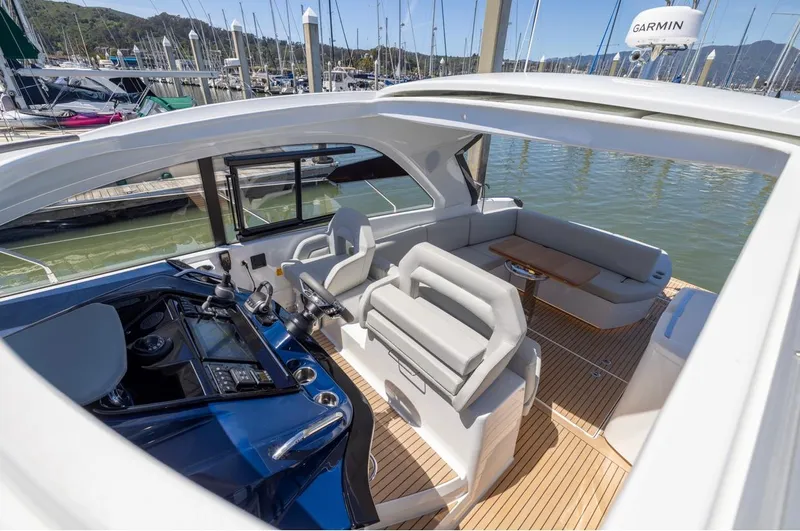 In Stock Yacht Photos Pics 2023 Beneteau Gran Turismo 41 yacht interior with modern helm and seating area.