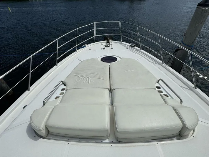  Yacht Photos Pics Luxury sunbathing deck on 2012 Azimut 64 yacht, featuring plush white cushions.