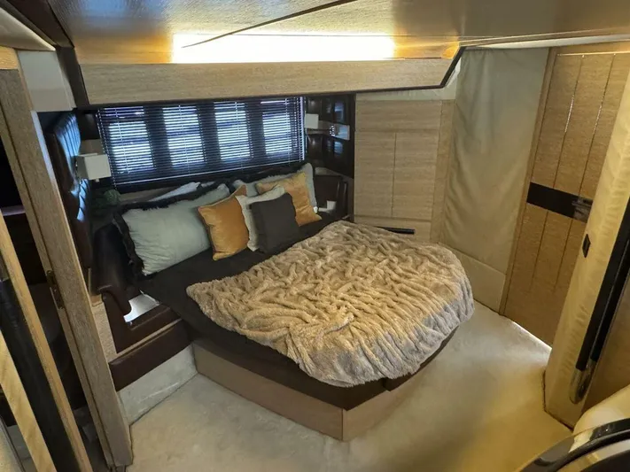  Yacht Photos Pics Luxurious bedroom interior of a 2012 Azimut 64 yacht with cozy bedding and modern design.
