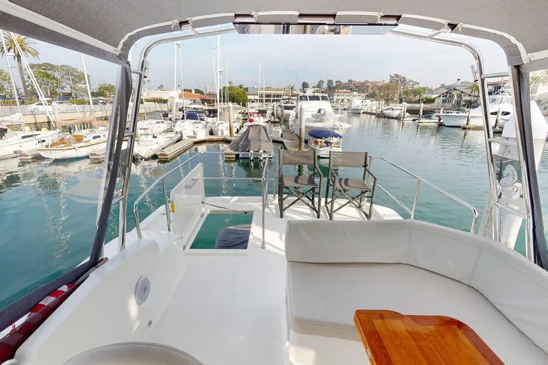 Vitamin Sea Yacht Photos Pics Beneteau Swift Trawler 35, 2021 model, docked in a marina with seating area.