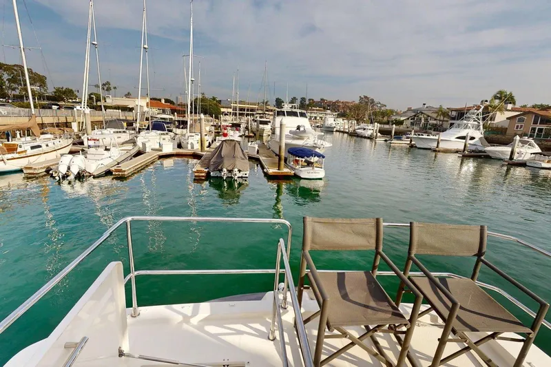 Vitamin Sea Yacht Photos Pics Beneteau Swift Trawler 35, 2021, docked in a marina with surrounding boats.