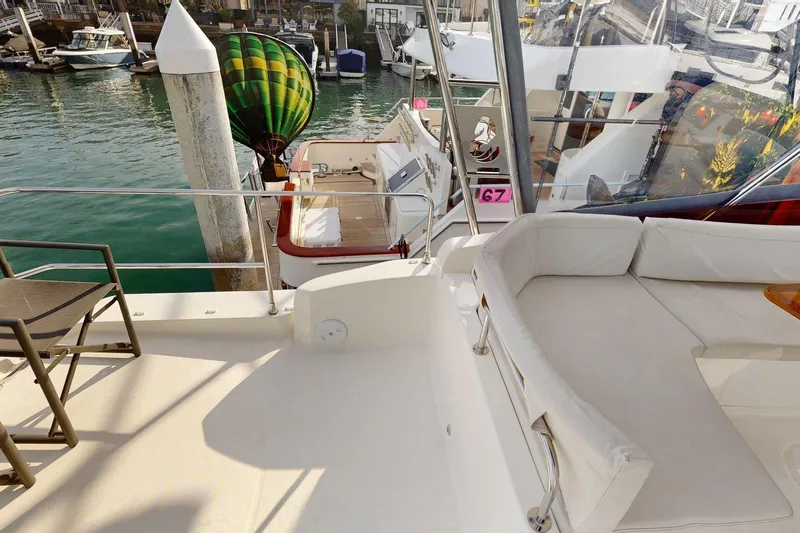 Vitamin Sea Yacht Photos Pics 2021 Beneteau Swift Trawler 35, spacious deck with seating, docked at marina.