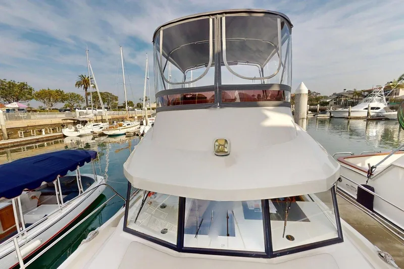 Vitamin Sea Yacht Photos Pics 2021 Beneteau Swift Trawler 35 docked in a marina, surrounded by other boats.