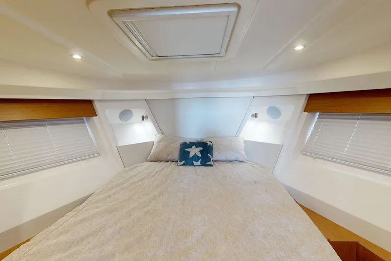 Vitamin Sea Yacht Photos Pics Interior cabin of 2021 Beneteau Swift Trawler 35 with cozy bed and starfish pillow.