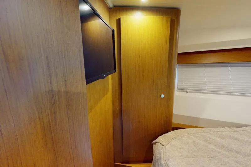 Vitamin Sea Yacht Photos Pics 2021 Beneteau Swift Trawler 35 cabin interior with wood paneling and TV.