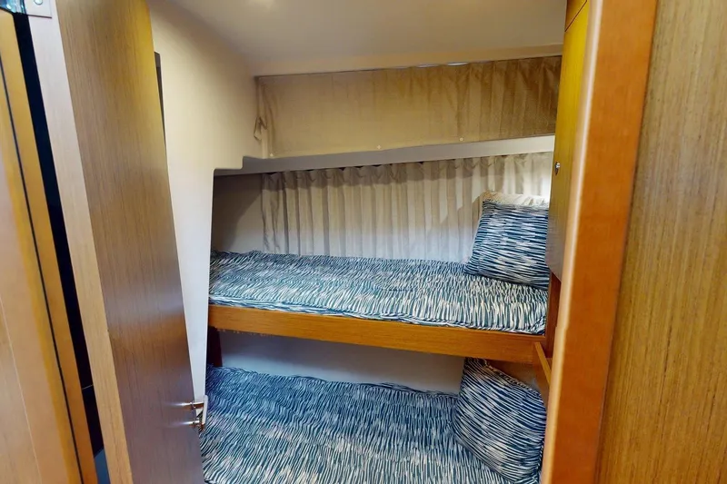Vitamin Sea Yacht Photos Pics 2021 Beneteau Swift Trawler 35 cabin with bunk beds and patterned bedding.