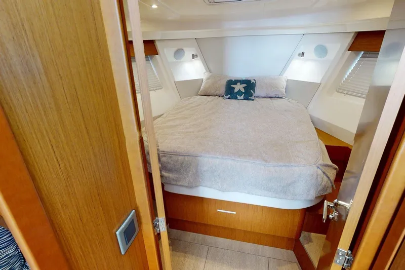 Vitamin Sea Yacht Photos Pics 2021 Beneteau Swift Trawler 35 cabin with cozy bed and nautical decor.
