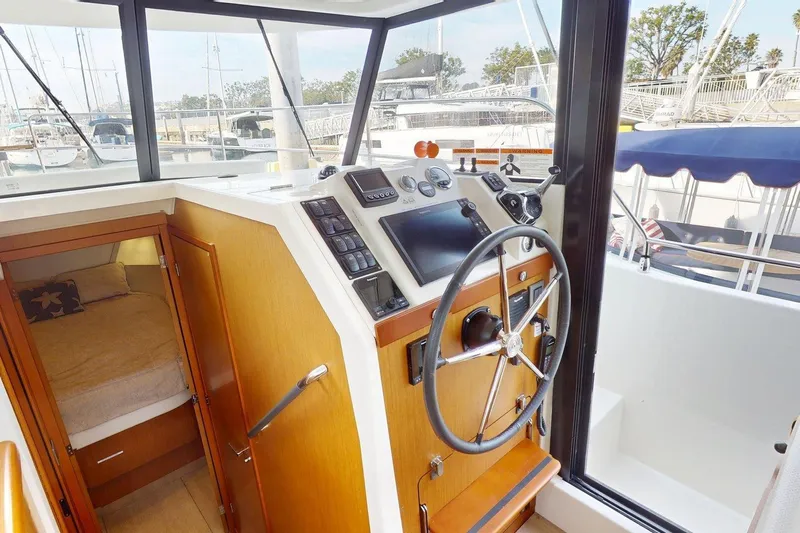 Vitamin Sea Yacht Photos Pics 2021 Beneteau Swift Trawler 35 helm station with steering wheel and cabin view.