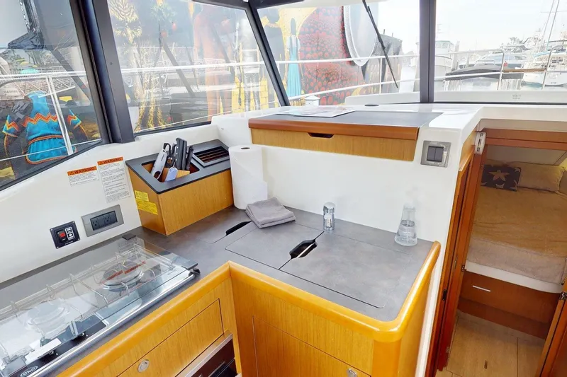 Vitamin Sea Yacht Photos Pics Interior of 2021 Beneteau Swift Trawler 35, featuring modern kitchen and cozy cabin.