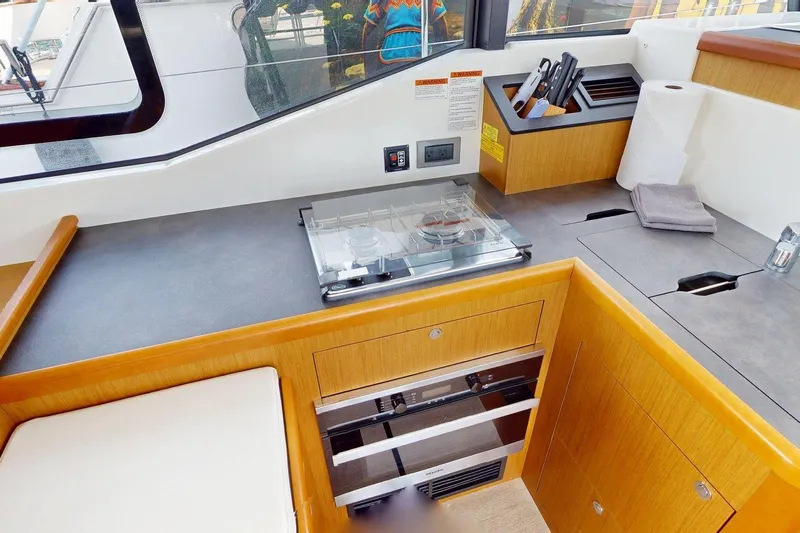 Vitamin Sea Yacht Photos Pics Modern kitchen area in 2021 Beneteau Swift Trawler 35 with stove and storage.