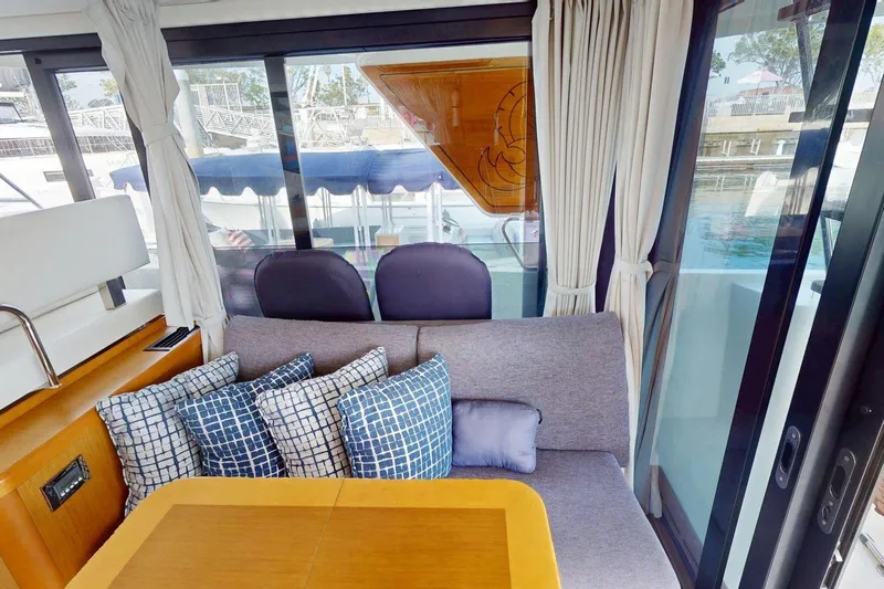 Vitamin Sea Yacht Photos Pics Interior of 2021 Beneteau Swift Trawler 35 with cozy seating and decorative pillows.