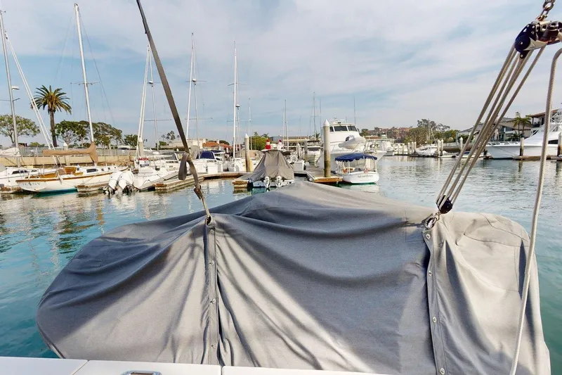 Vitamin Sea Yacht Photos Pics 2021 Beneteau Swift Trawler 35 docked in a marina, covered with a protective tarp.