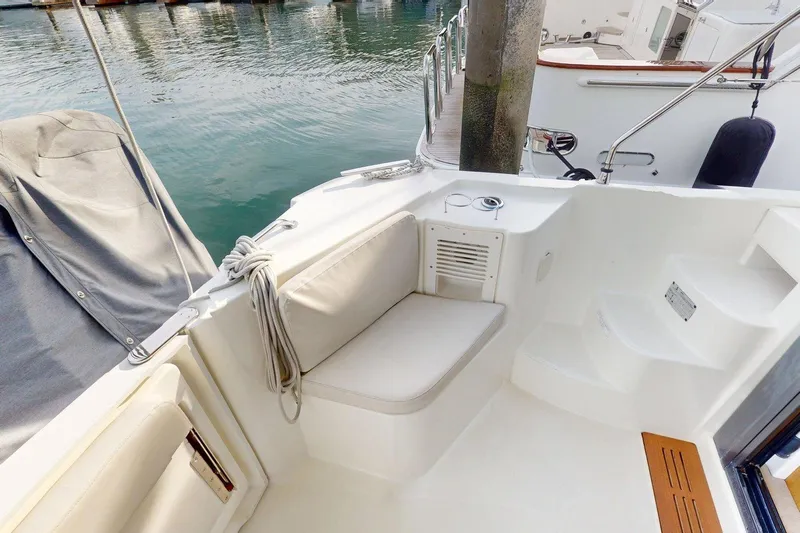 Vitamin Sea Yacht Photos Pics 2021 Beneteau Swift Trawler 35 cockpit with seating, steps, and dock view.