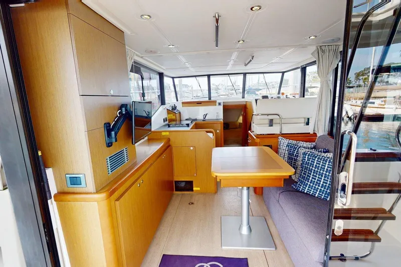 Vitamin Sea Yacht Photos Pics Interior of 2021 Beneteau Swift Trawler 35, featuring modern wood finishes and seating area.