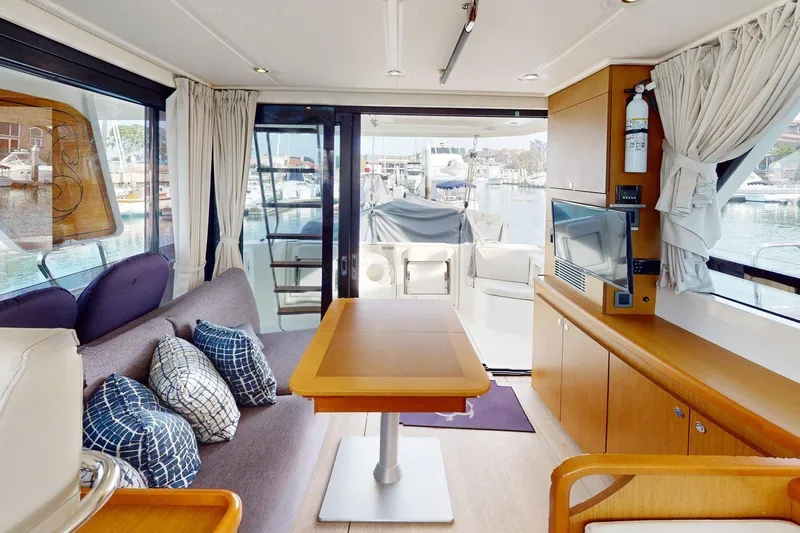 Vitamin Sea Yacht Photos Pics Interior of 2021 Beneteau Swift Trawler 35, featuring modern seating and a view of the marina.