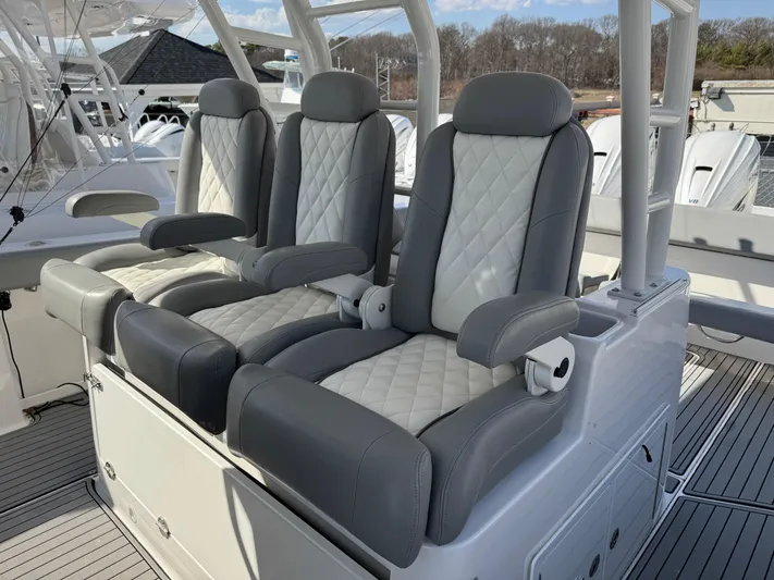  Yacht Photos Pics Luxurious seating on 2022 Everglades 395cc boat, featuring quilted upholstery and armrests.