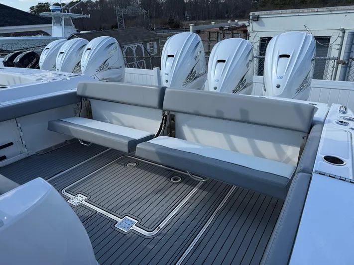  Yacht Photos Pics 2022 Everglades 395cc boat with multiple outboard engines and spacious seating area.