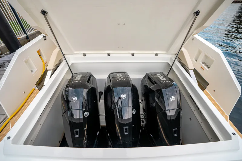  Yacht Photos Pics 2025 De Antonio Yachts D42 Open with triple outboard engines in open compartment.