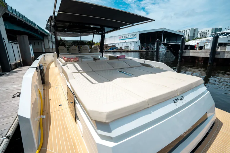  Yacht Photos Pics 2025 De Antonio Yachts D42 Open luxury yacht docked, featuring spacious sunbathing area.