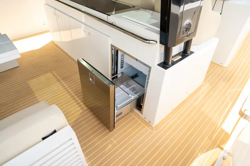  Yacht Photos Pics 2025 De Antonio Yachts D42 Open interior with open drawer on sleek wooden deck.