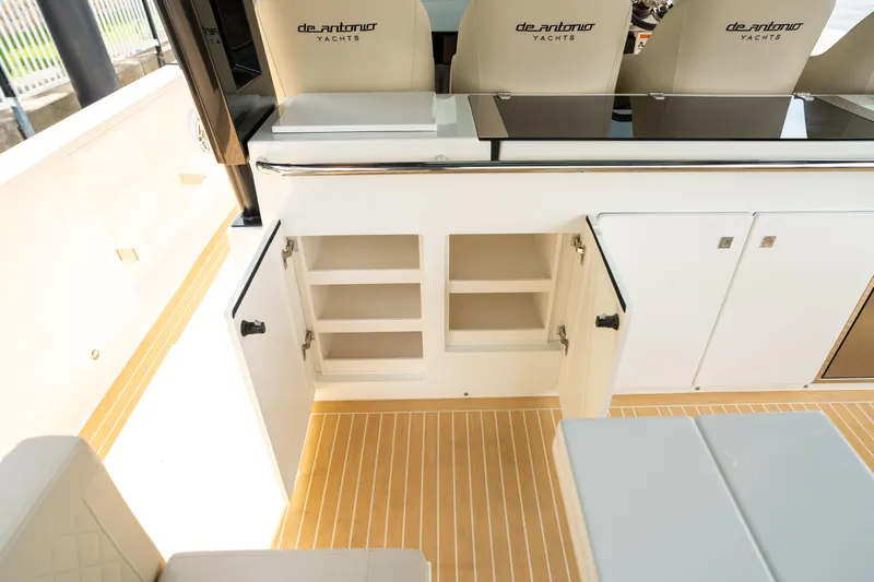  Yacht Photos Pics 2025 De Antonio Yachts D42 Open interior with open storage cabinets and sleek seating.