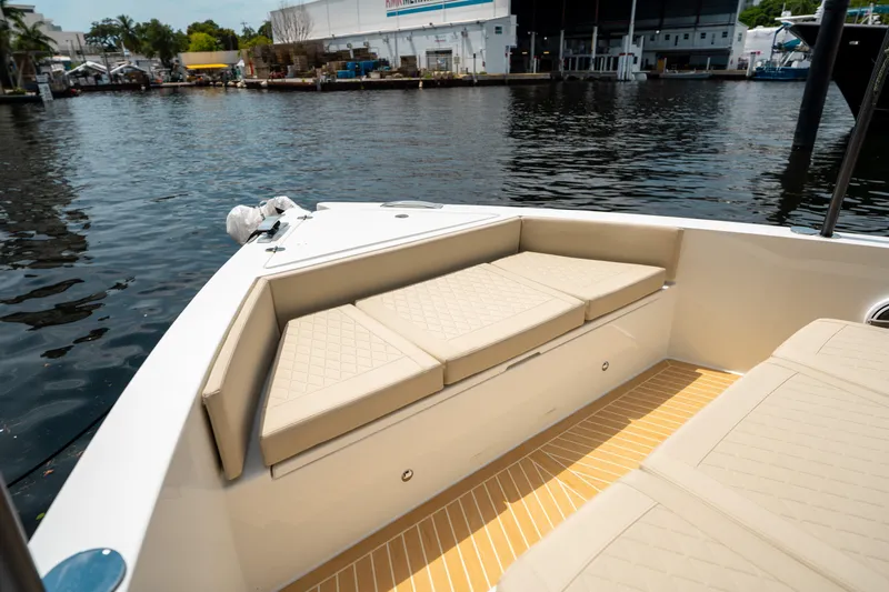  Yacht Photos Pics 2025 De Antonio Yachts D42 Open, featuring beige seating, docked by the water.