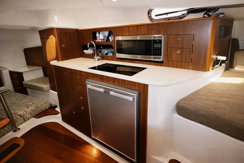 Cast Strength Yacht Photos Pics Interior of 2016 Pursuit OS 345 Offshore with modern kitchen.