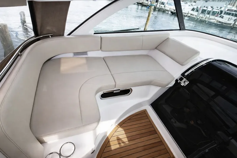 Cast Strength Yacht Photos Pics Interior of 2016 Pursuit OS 345 Offshore with beige seating area.