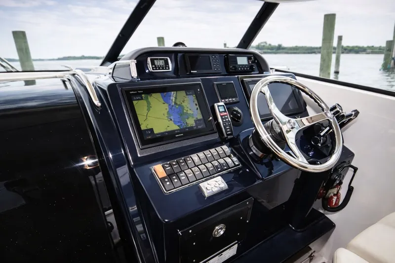 Cast Strength Yacht Photos Pics 2016 Pursuit OS 345 Offshore helm with navigation system.