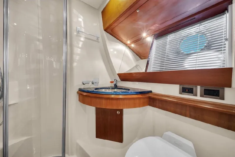  Yacht Photos Pics Luxurious bathroom interior of 2005 Azimut 50 yacht with modern fixtures and wood accents.
