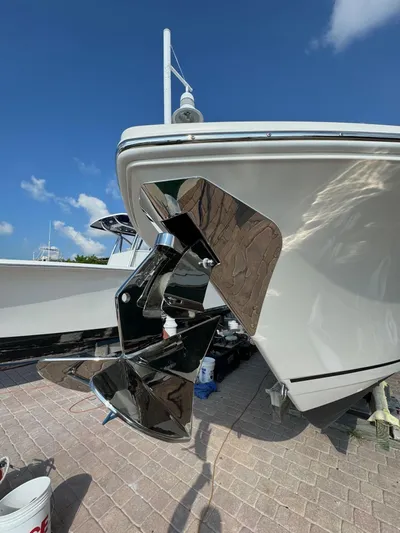  Yacht Photos Pics 2023 Sailfish 290cc boat with shiny stainless steel propeller, docked under clear blue sky.