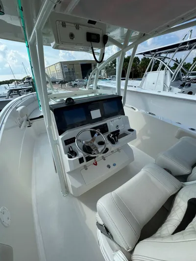  Yacht Photos Pics 2023 Sailfish 290cc boat cockpit with modern controls and seating.