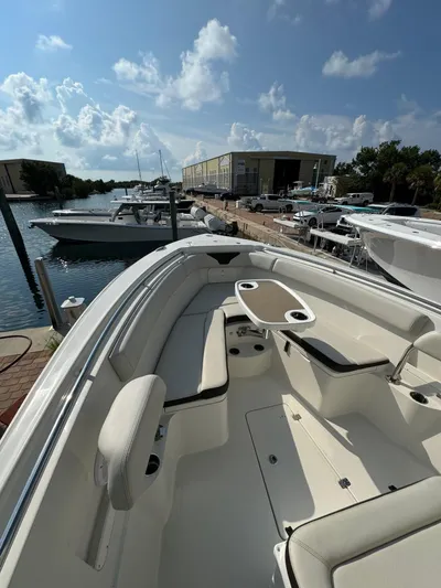 Yacht Photos Pics 2023 Sailfish 290cc boat docked at marina under a partly cloudy sky.
